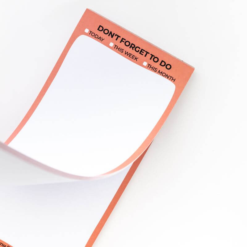 Notepad with 'Don't Forget To Do' text with an orange border on a white background