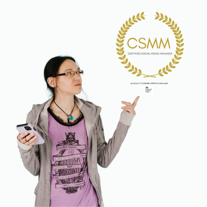 Jeni wearing a purple t-shirt and grey hoodie pointing to a 'CSMM' certification logo on a white background